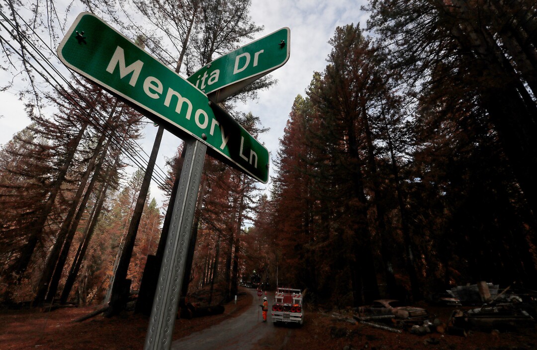 Work crews clear burned trees along Memory Lane in Boulder Creek.